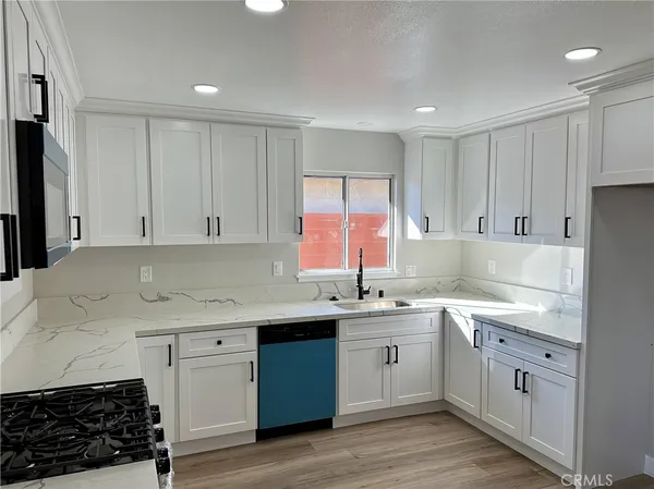 a kitchen with a sink stove and cabinets