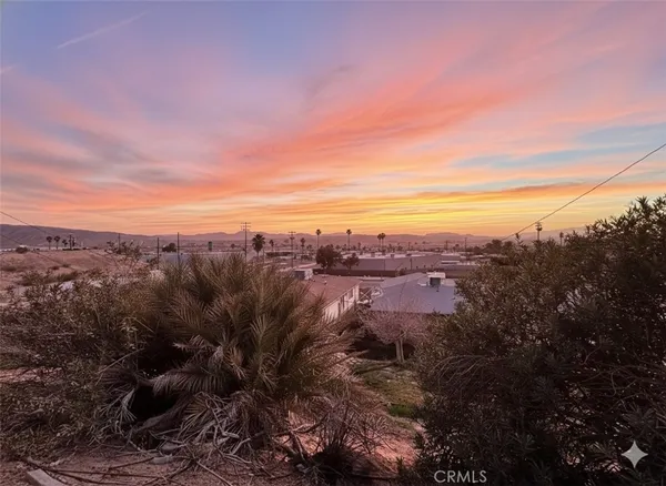 a view of a city with lush green forest