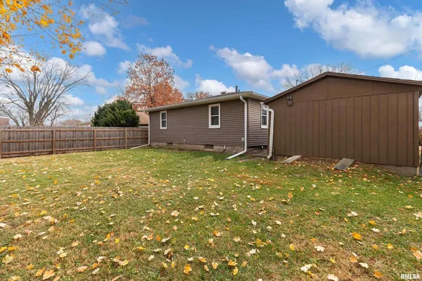 a view of a yard with a house and large tree