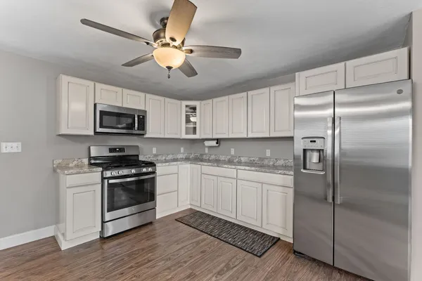 a kitchen with a refrigerator stove and microwave