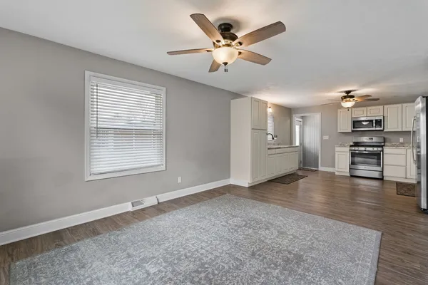 a view of a kitchen with a sink cabinets and wooden floor