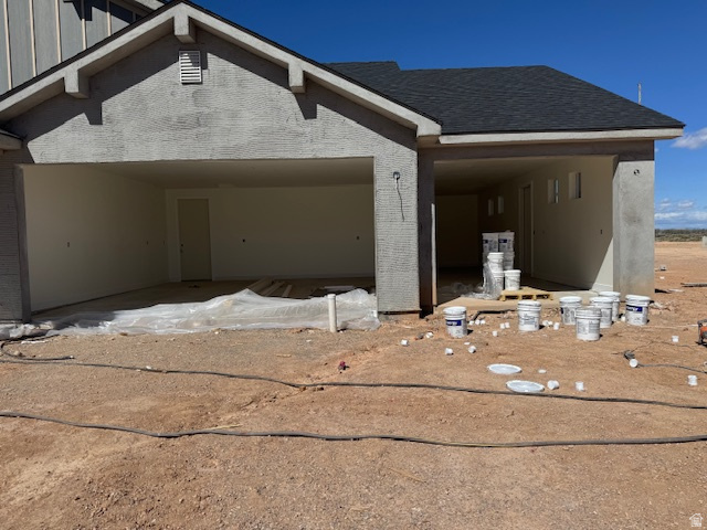 5005 North 75 East Enoch, UT 84721 - Photo 6 of 37 View of property exterior featuring brick siding, a shingled roof, and board and batten siding