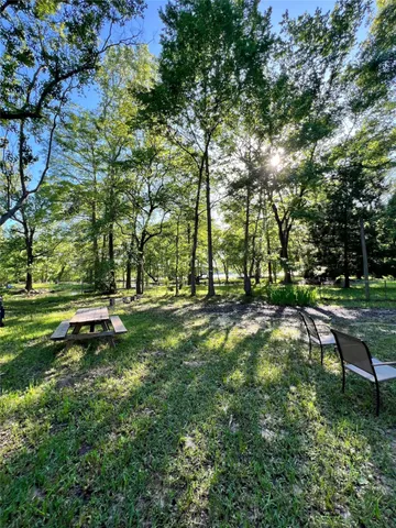 a backyard of a house with a yard and outdoor seating