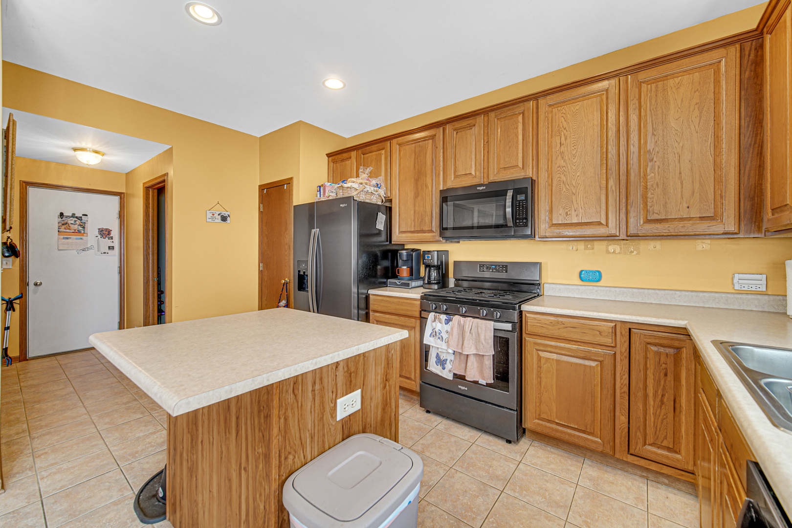 188 Breckenridge Court Gilberts, IL 60136 - Photo 6 of 25 a kitchen with stainless steel appliances a stove a sink a microwave a refrigerator and white cabinets