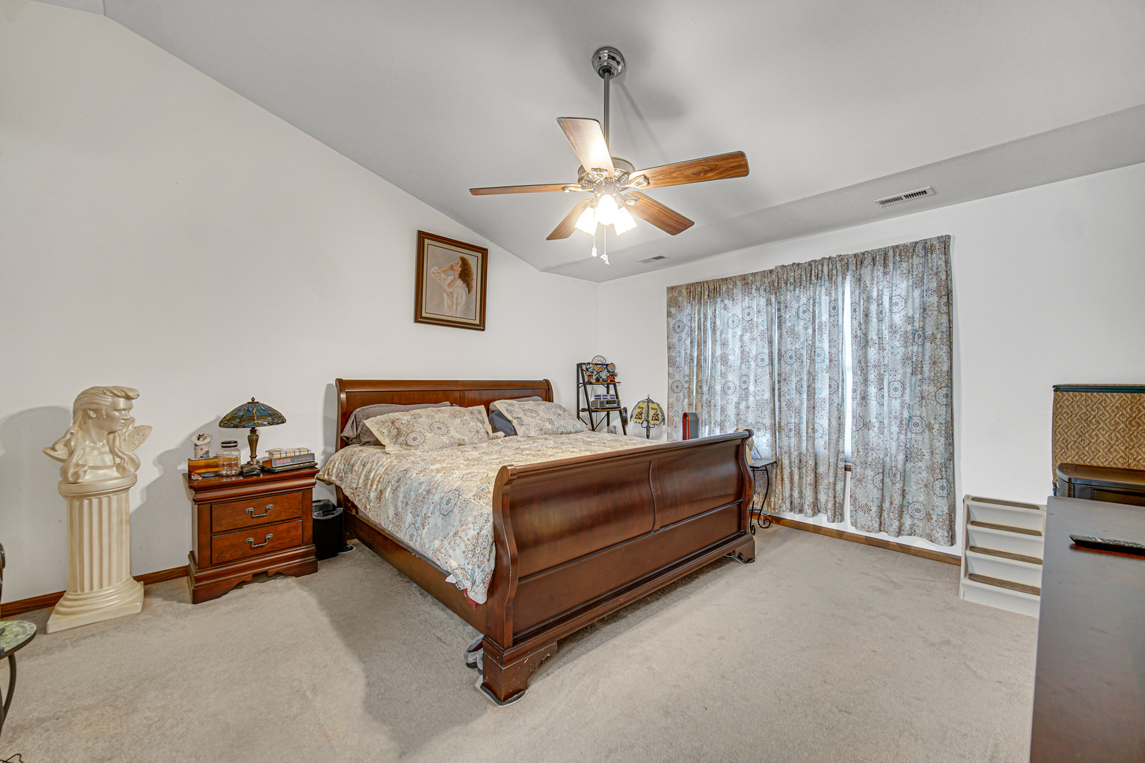 188 Breckenridge Court Gilberts, IL 60136 - Photo 10 of 25 a spacious bedroom with a bed and a chandelier