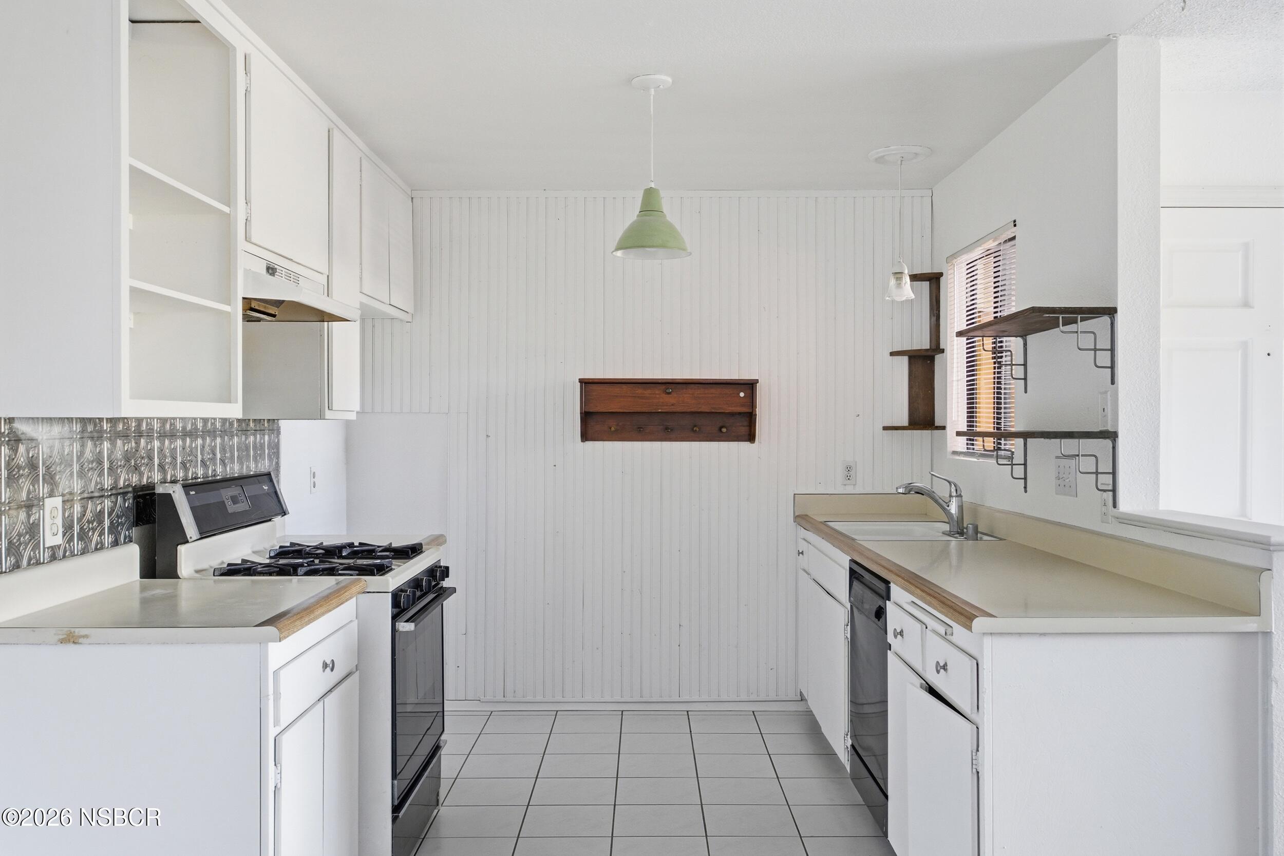 3350 Santa Maria Way, Unit 104A Santa Maria, CA 93455 - Photo 11 of 23 a kitchen with a sink stove and cabinets