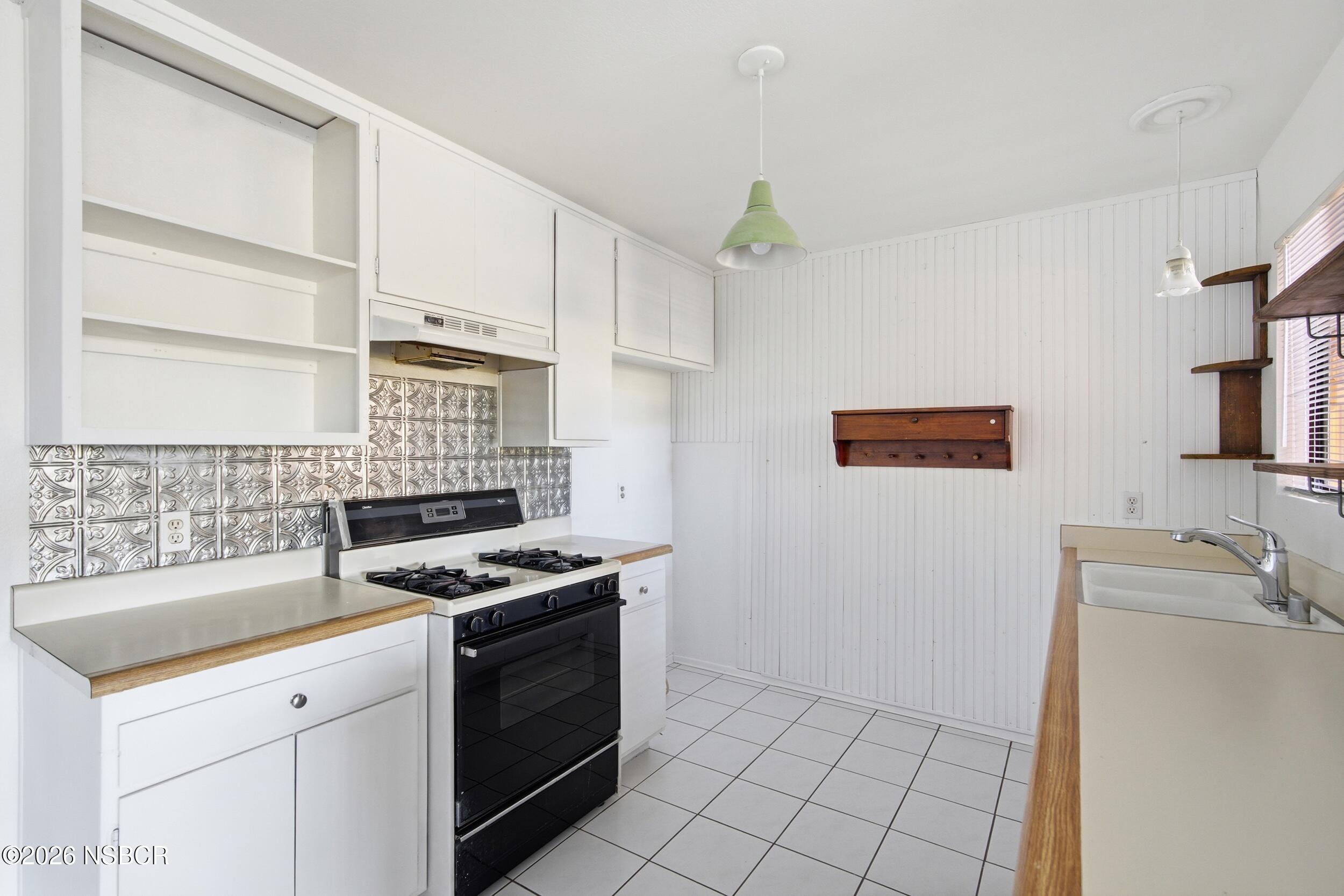 3350 Santa Maria Way, Unit 104A Santa Maria, CA 93455 - Photo 12 of 23 a kitchen with granite countertop a stove and a sink