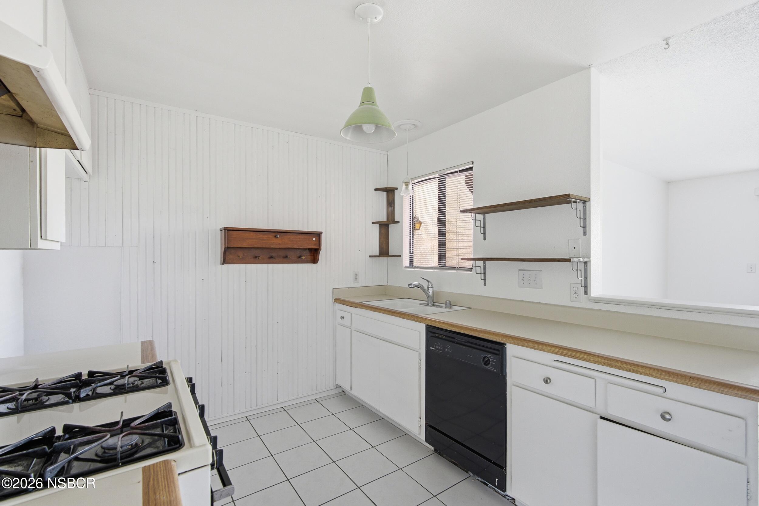 3350 Santa Maria Way, Unit 104A Santa Maria, CA 93455 - Photo 13 of 23 a kitchen with a sink and a stove top oven