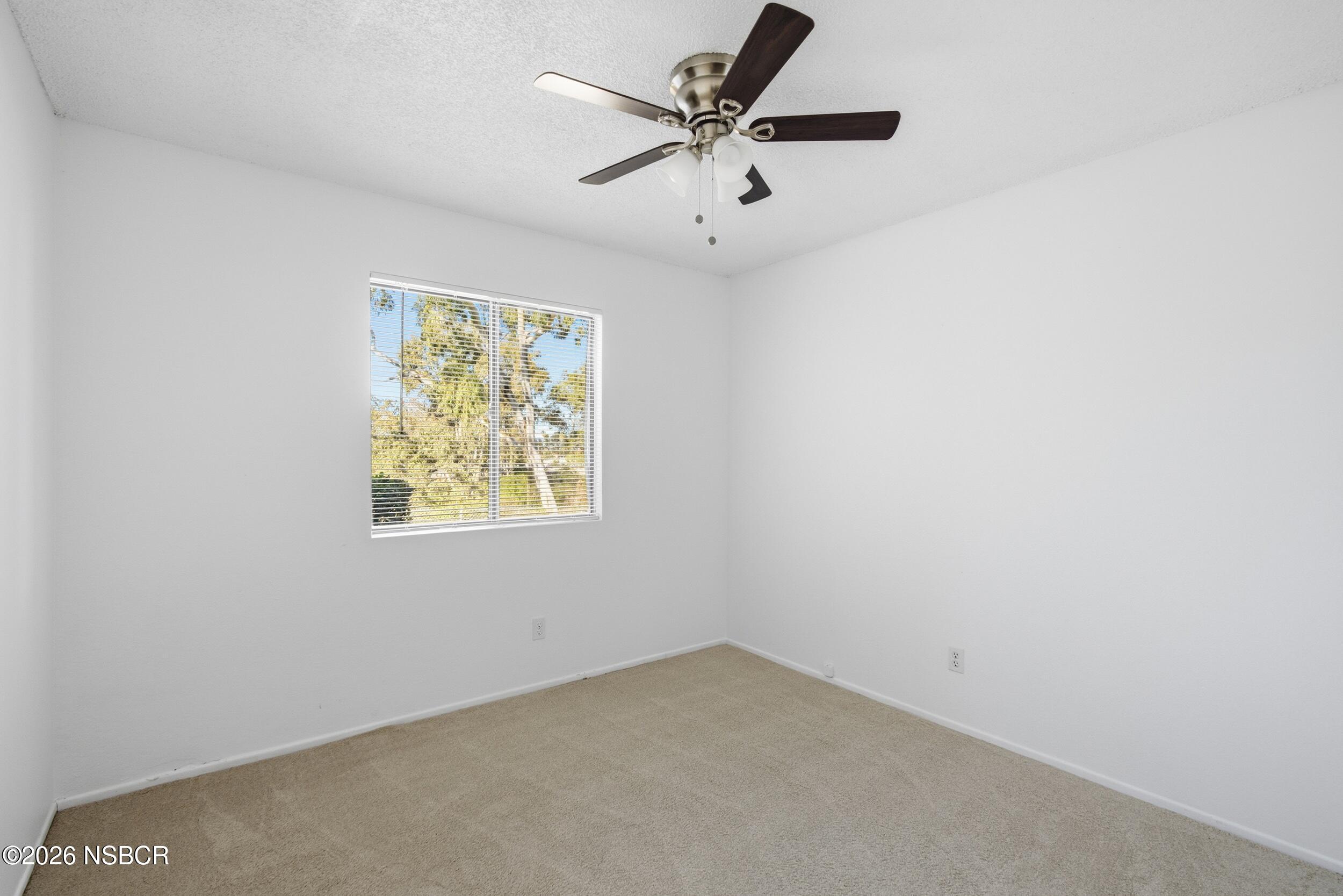 3350 Santa Maria Way, Unit 104A Santa Maria, CA 93455 - Photo 14 of 23 an empty room with a window and a ceiling fan