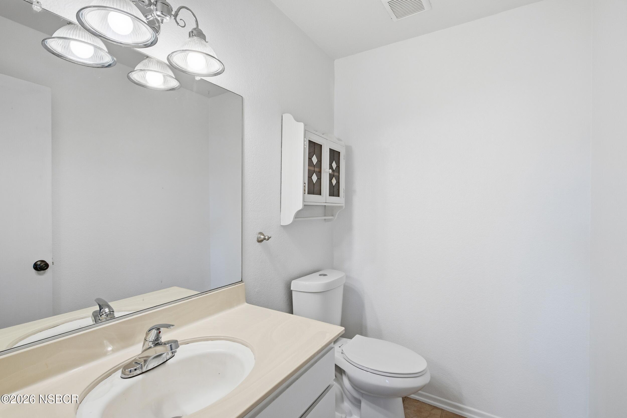 3350 Santa Maria Way, Unit 104A Santa Maria, CA 93455 - Photo 15 of 23 a bathroom with a sink a toilet and a mirror