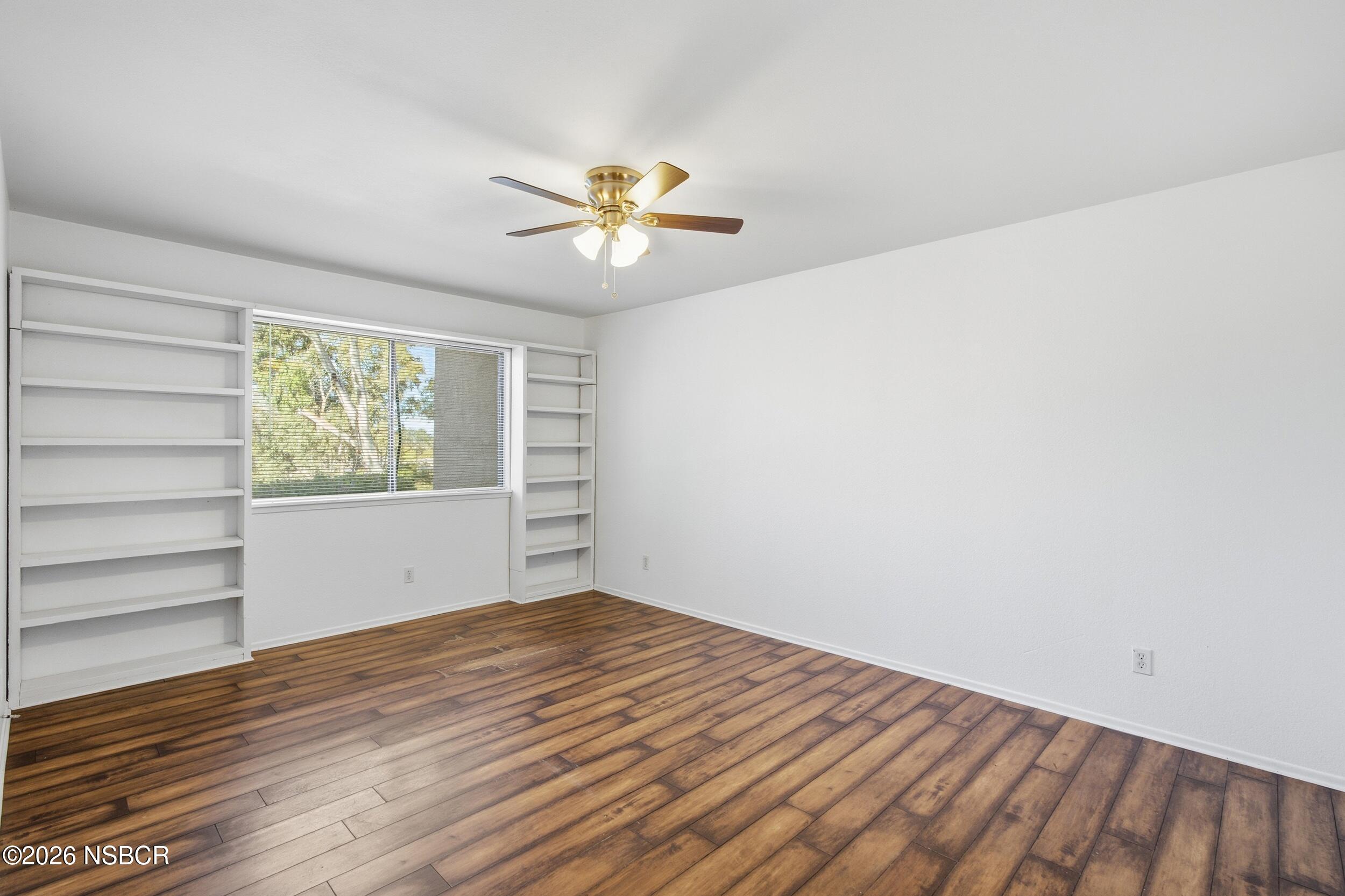 3350 Santa Maria Way, Unit 104A Santa Maria, CA 93455 - Photo 16 of 23 a view of an empty room with a window and wooden floor