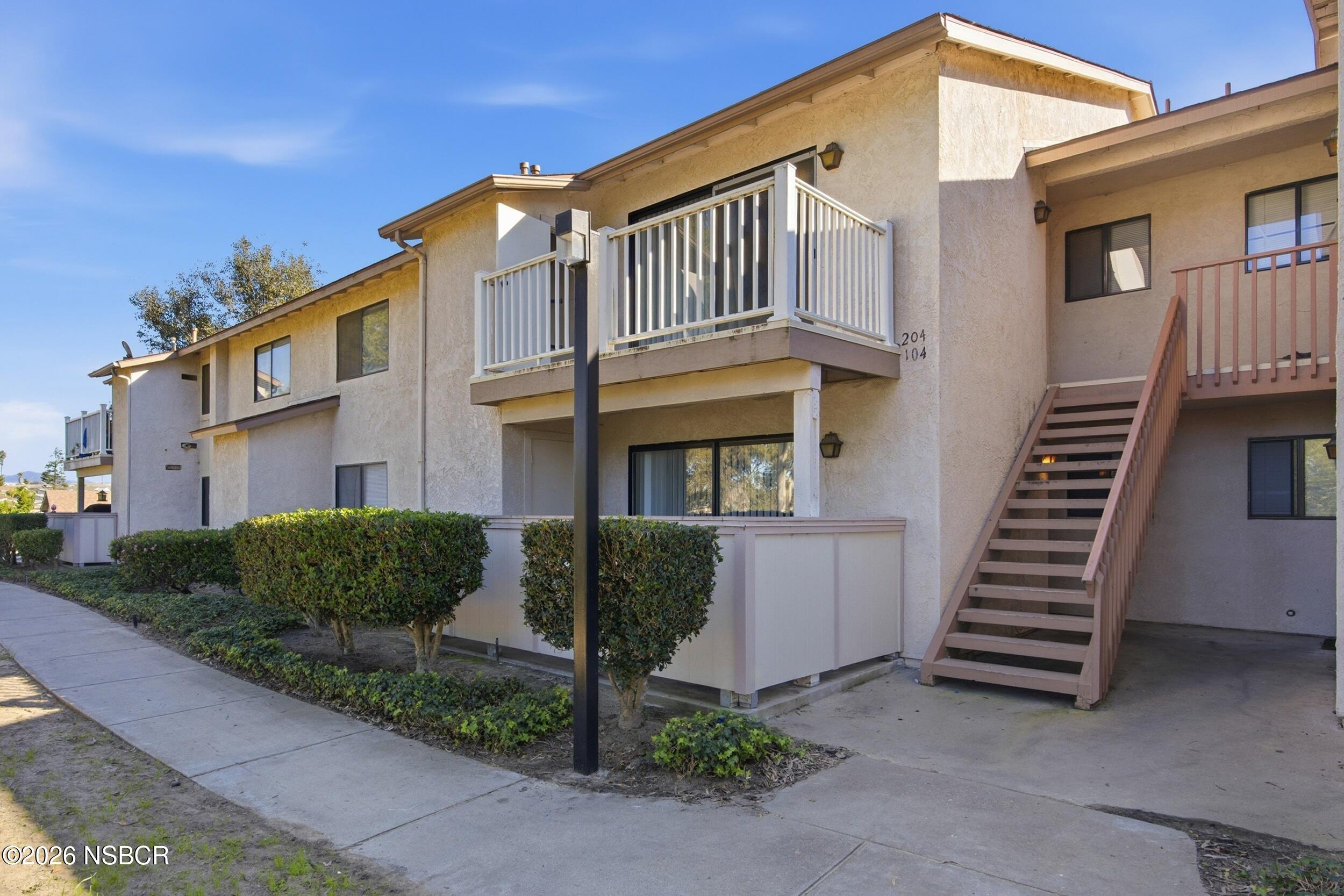 3350 Santa Maria Way, Unit 104A Santa Maria, CA 93455 - Photo 2 of 23 a front view of a house with a yard