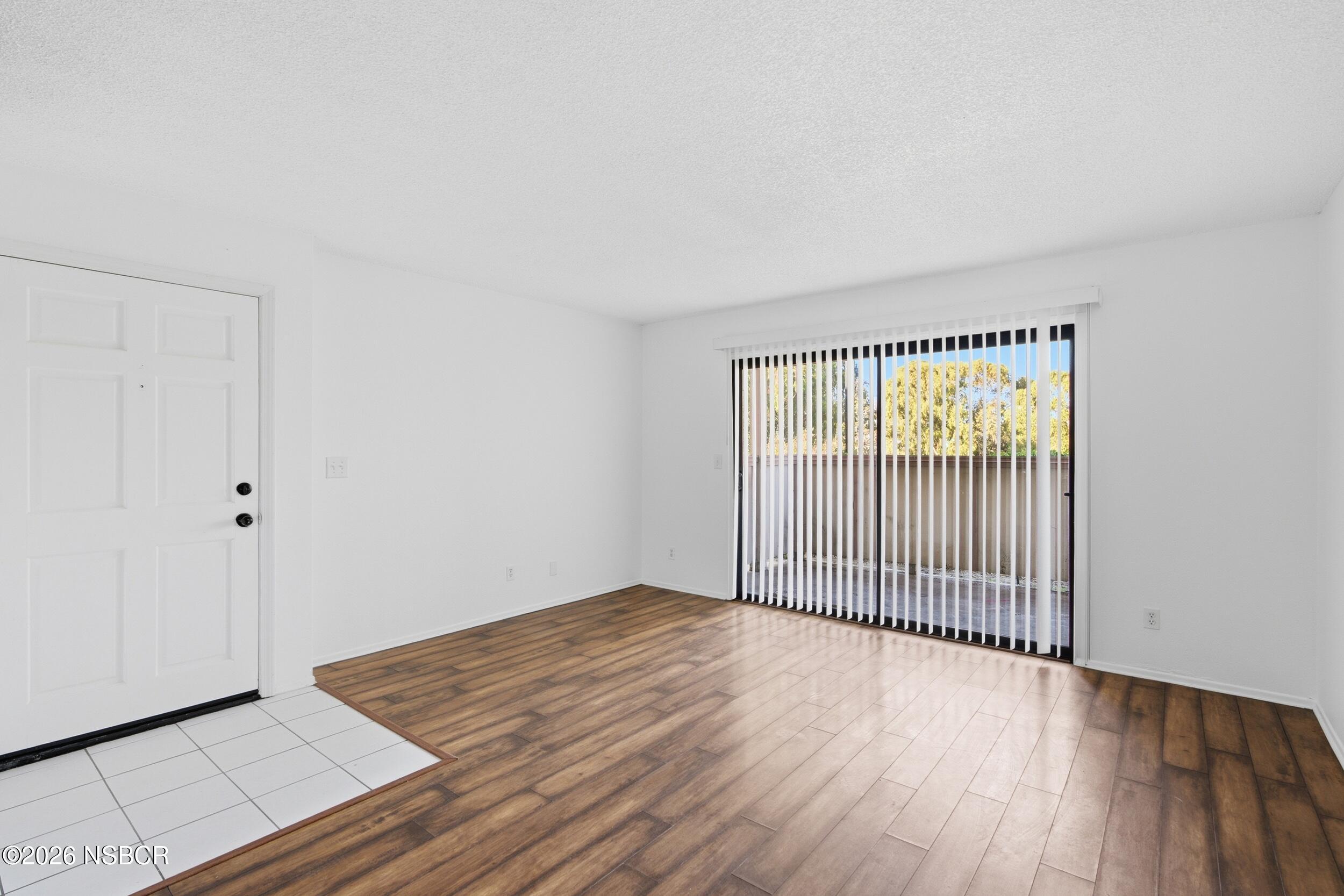 3350 Santa Maria Way, Unit 104A Santa Maria, CA 93455 - Photo 4 of 23 a view of a room with wooden floor and windows