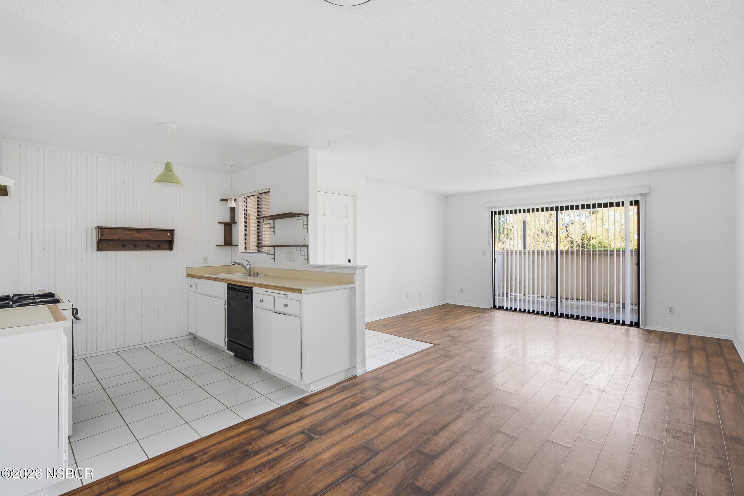 3350 Santa Maria Way, Unit 104A Santa Maria, CA 93455 - Photo 9 of 23 a view of a kitchen with wooden floor and electronic appliances
