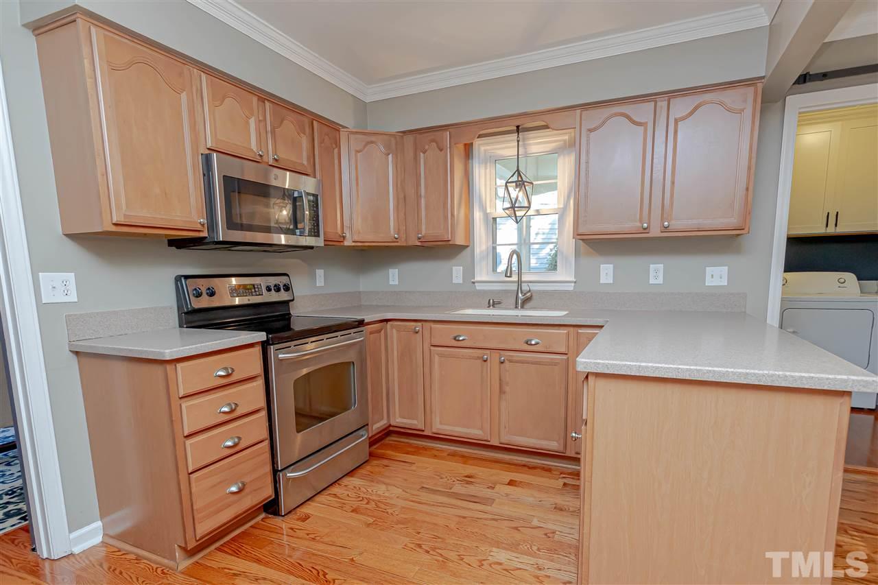 1212 Oakside Court Raleigh, NC 27609 - Photo 13 of 25 a kitchen with stainless steel appliances granite countertop a sink a stove and a microwave