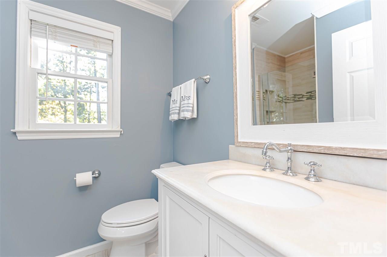 1212 Oakside Court Raleigh, NC 27609 - Photo 18 of 25 a bathroom with a sink toilet and a window