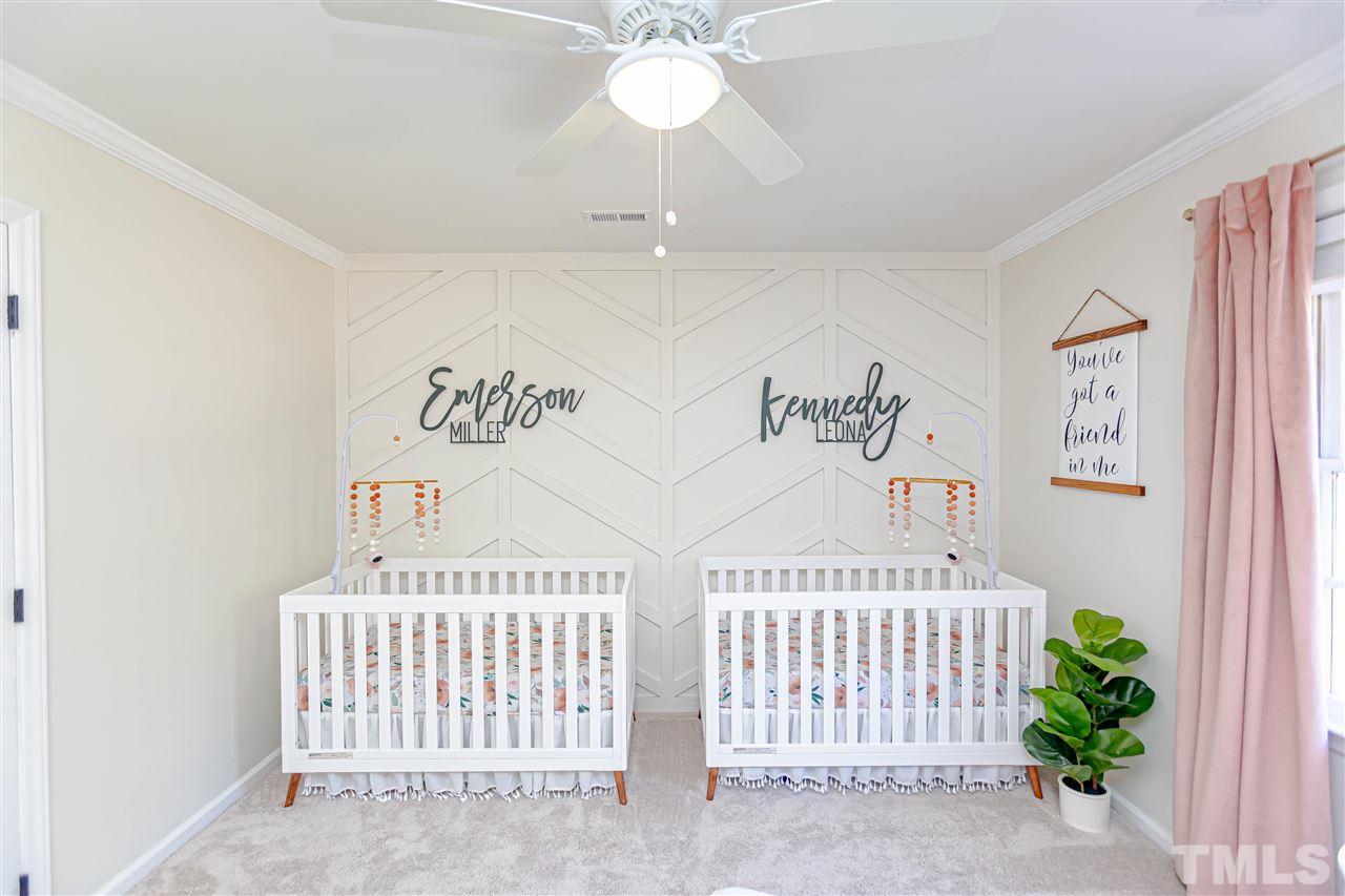 1212 Oakside Court Raleigh, NC 27609 - Photo 23 of 25 a bedroom with a bed and a baby crib