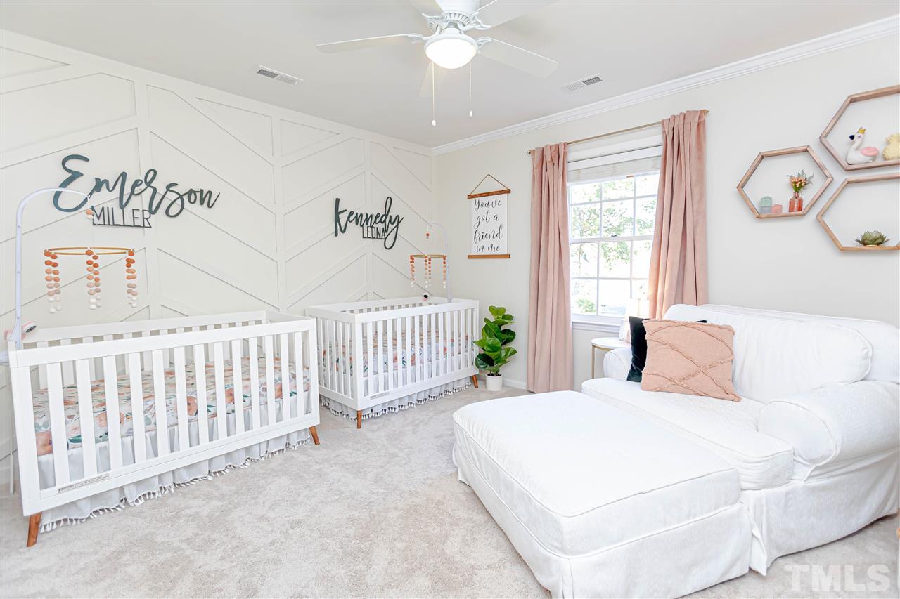 1212 Oakside Court Raleigh, NC 27609 - Photo 24 of 25 a bedroom with a white bed and a window