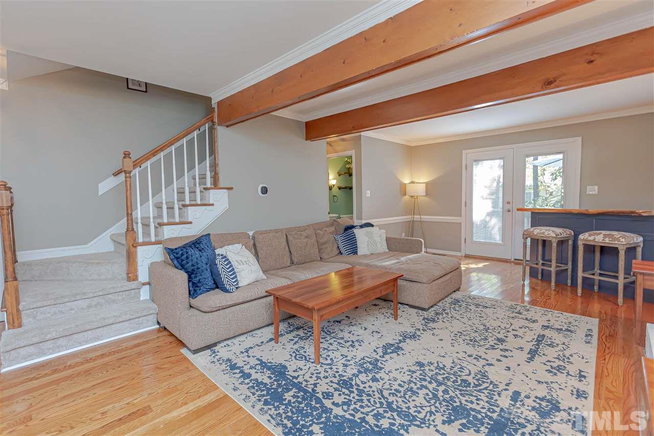 1212 Oakside Court Raleigh, NC 27609 - Photo 4 of 25 a living room with furniture and a dining table