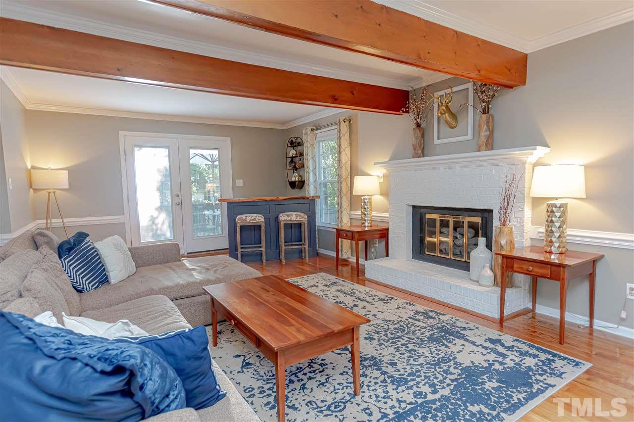 1212 Oakside Court Raleigh, NC 27609 - Photo 5 of 25 a living room with furniture and a fireplace