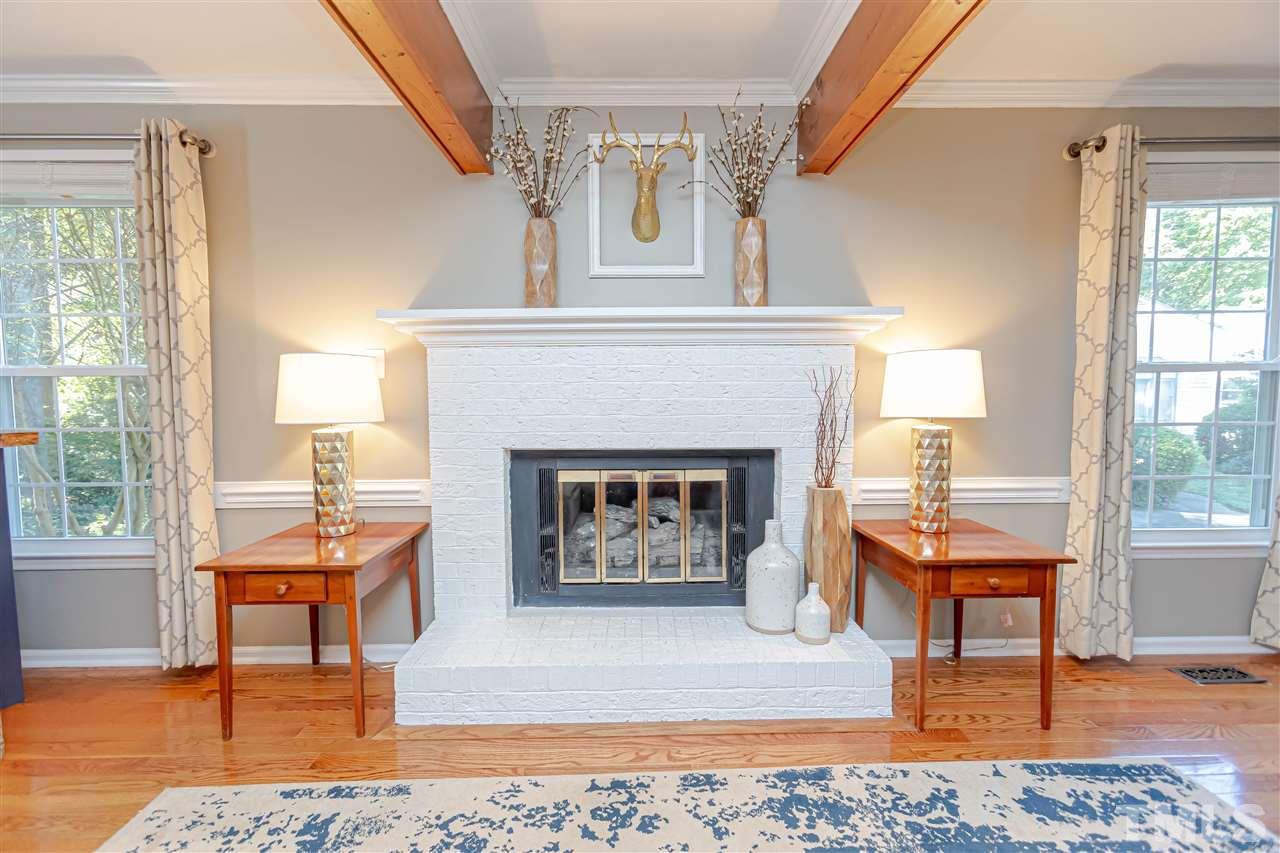 1212 Oakside Court Raleigh, NC 27609 - Photo 7 of 25 a living room with furniture and a fireplace