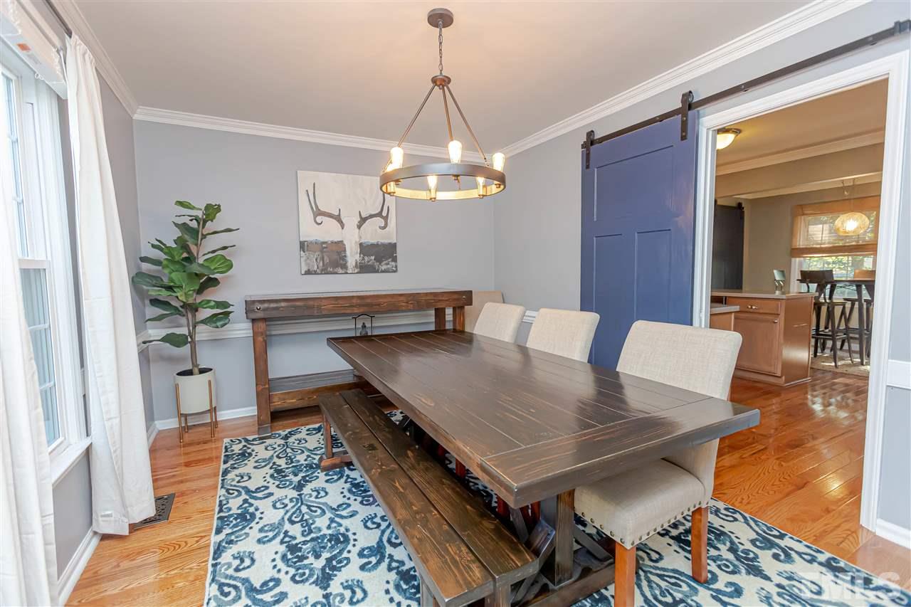 1212 Oakside Court Raleigh, NC 27609 - Photo 9 of 25 a living room with dining table