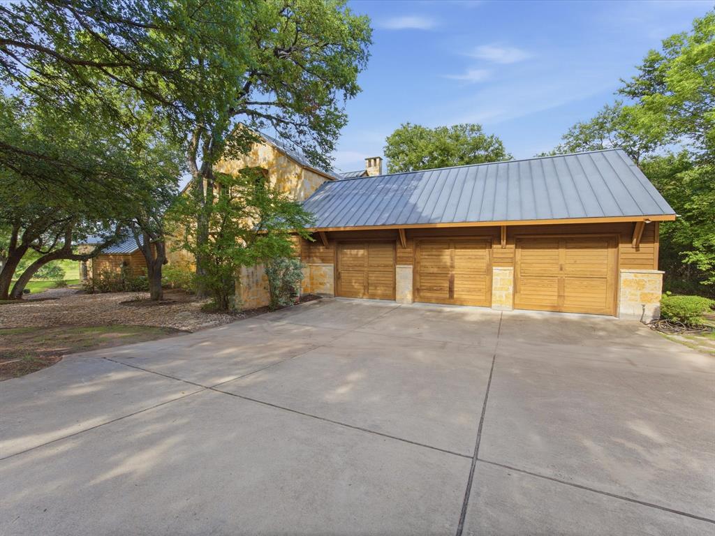 151 Trinity Bluffs Road Aledo, TX 76008 - Photo 5 of 40 a house with a trees in the background