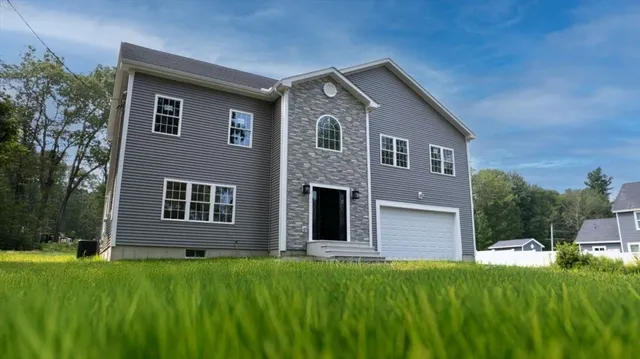 a front view of a house with a yard