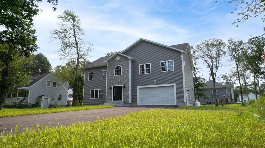 217 Prospect Street Auburn, MA 01501 - Photo 1 of 41 a front view of house with yard and trees in the background