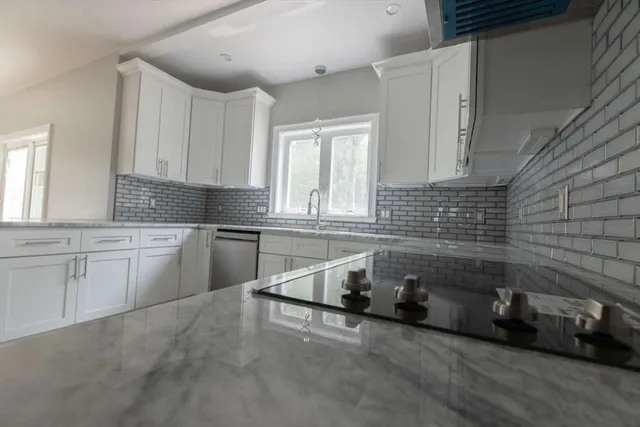 a kitchen with sink cabinets and window
