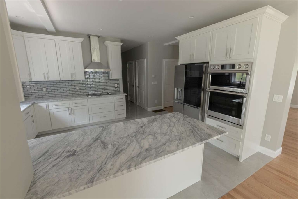 217 Prospect Street Auburn, MA 01501 - Photo 13 of 41 a kitchen with granite countertop a refrigerator and a sink