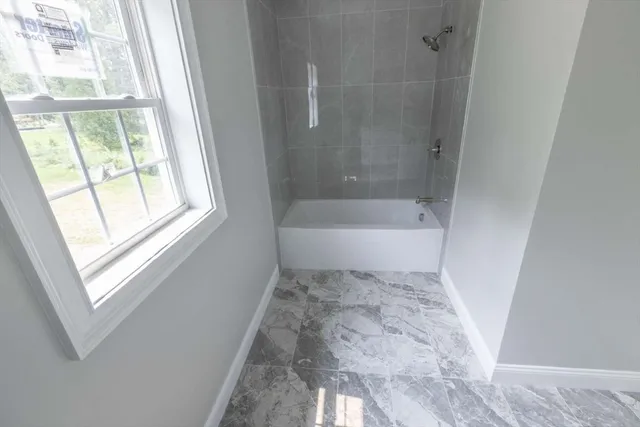 a bathroom with a bathtub and a shower