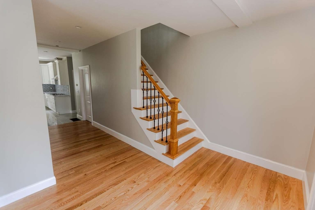 217 Prospect Street Auburn, MA 01501 - Photo 21 of 41 a view of a hallway with wooden floor and staircase