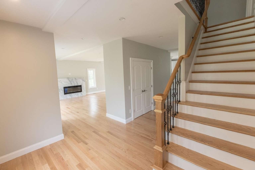 217 Prospect Street Auburn, MA 01501 - Photo 22 of 41 a view of a hallway with wooden floor and staircase