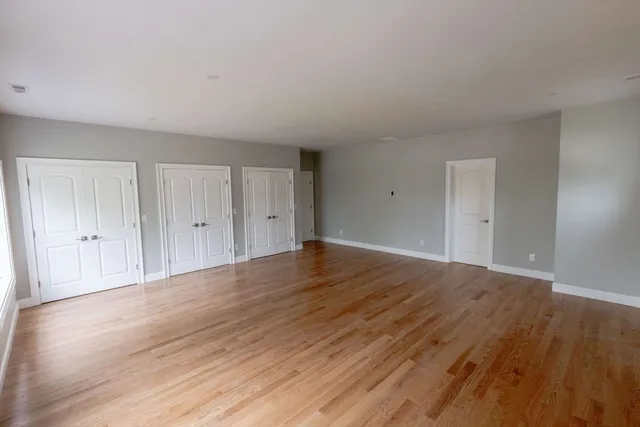 a view of an empty room and wooden floor