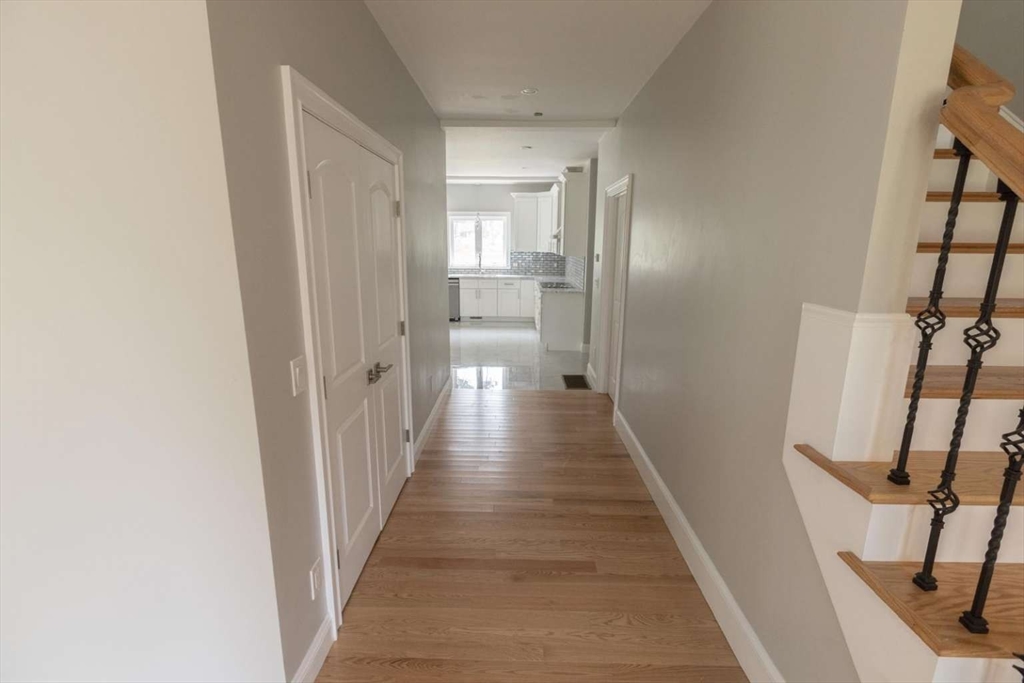 217 Prospect Street Auburn, MA 01501 - Photo 27 of 41 a view of a hallway with wooden floor and staircase
