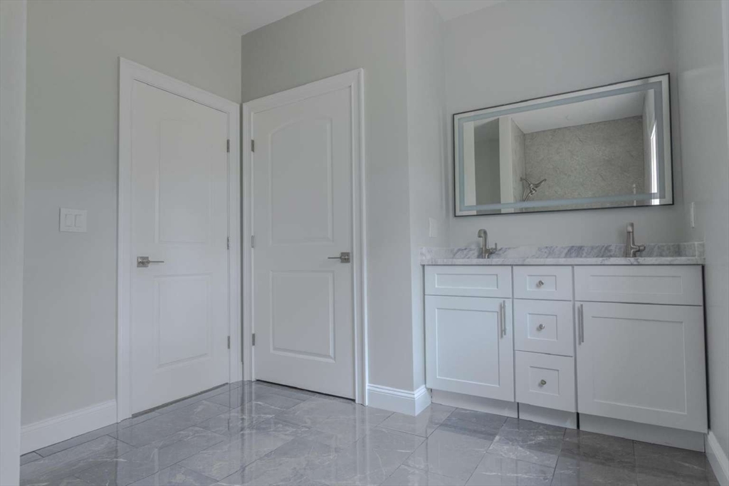 217 Prospect Street Auburn, MA 01501 - Photo 28 of 41 a bathroom with a sink vanity and mirror