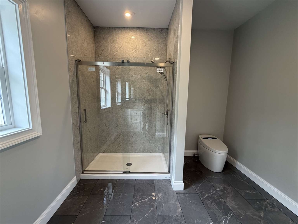 217 Prospect Street Auburn, MA 01501 - Photo 29 of 41 a bathroom with a granite countertop toilet and a shower