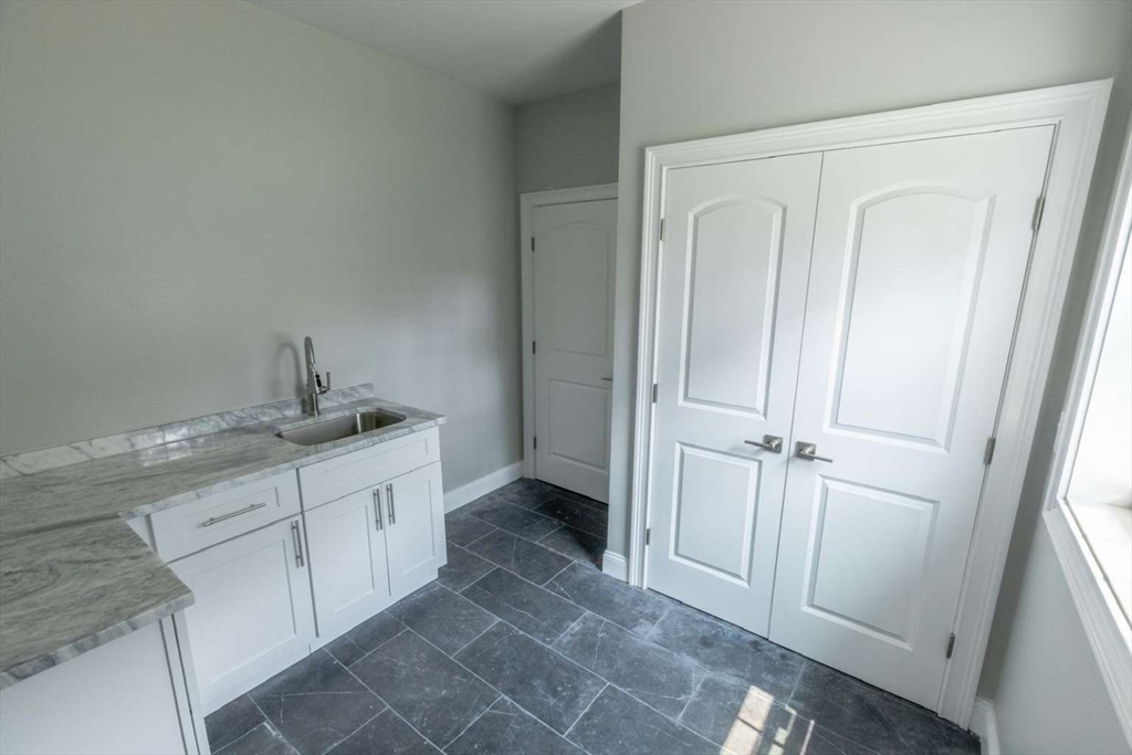 217 Prospect Street Auburn, MA 01501 - Photo 30 of 41 a bathroom with a granite countertop sink and a mirror