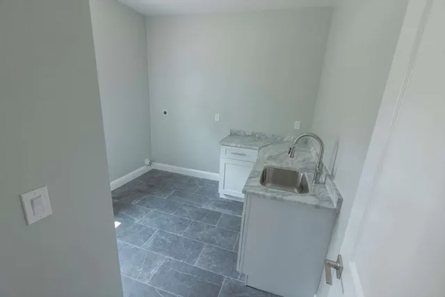 a room with a sink and washing machine