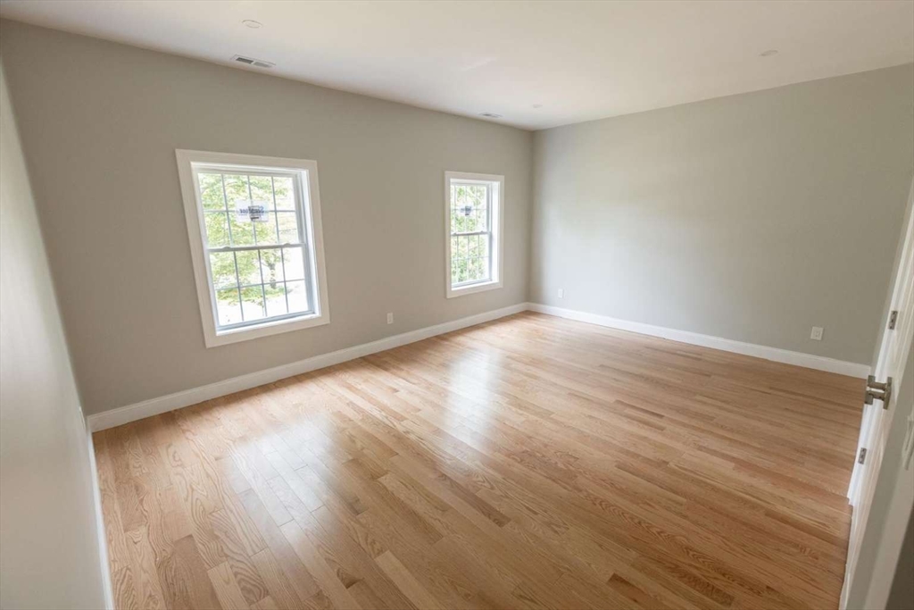 217 Prospect Street Auburn, MA 01501 - Photo 39 of 41 a view of an empty room with wooden floor and window