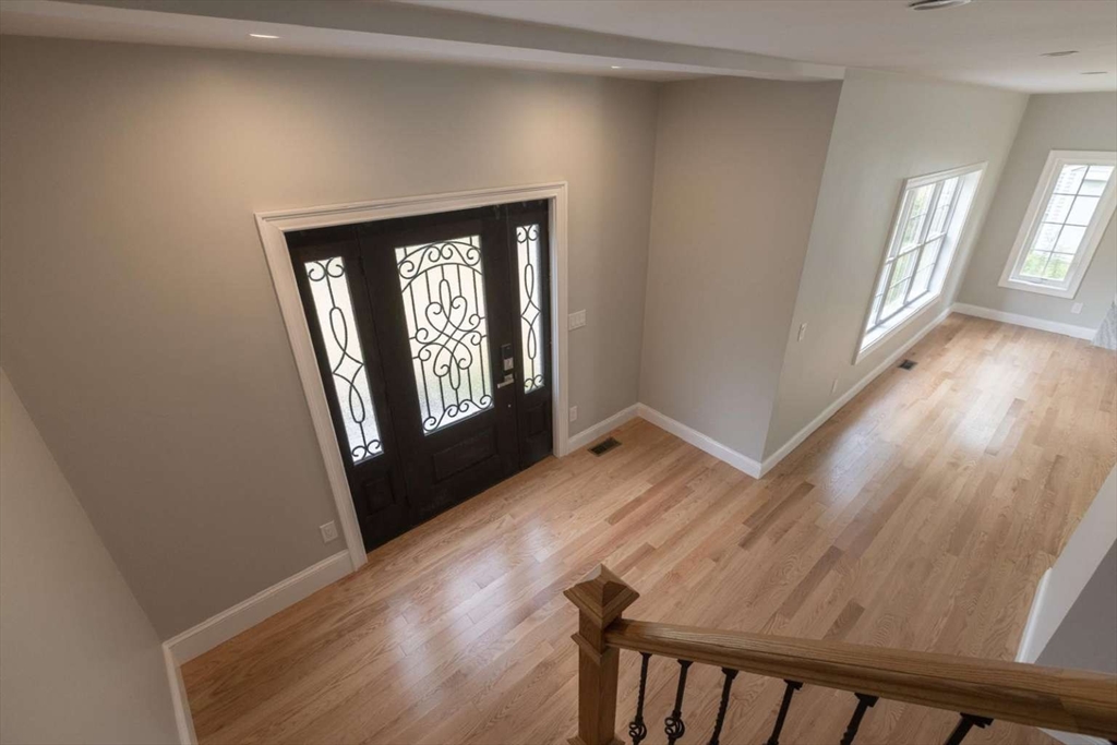 217 Prospect Street Auburn, MA 01501 - Photo 6 of 41 a view of a hallway with wooden floor and stairs