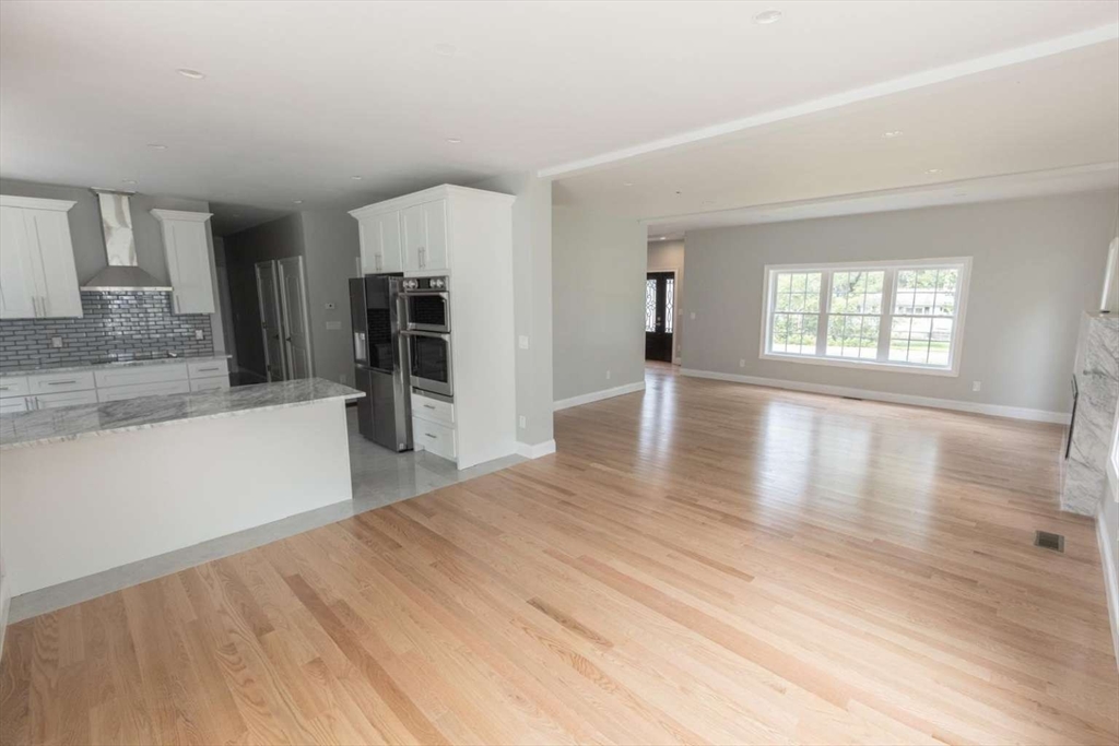217 Prospect Street Auburn, MA 01501 - Photo 8 of 41 an empty room with wooden floor and a window