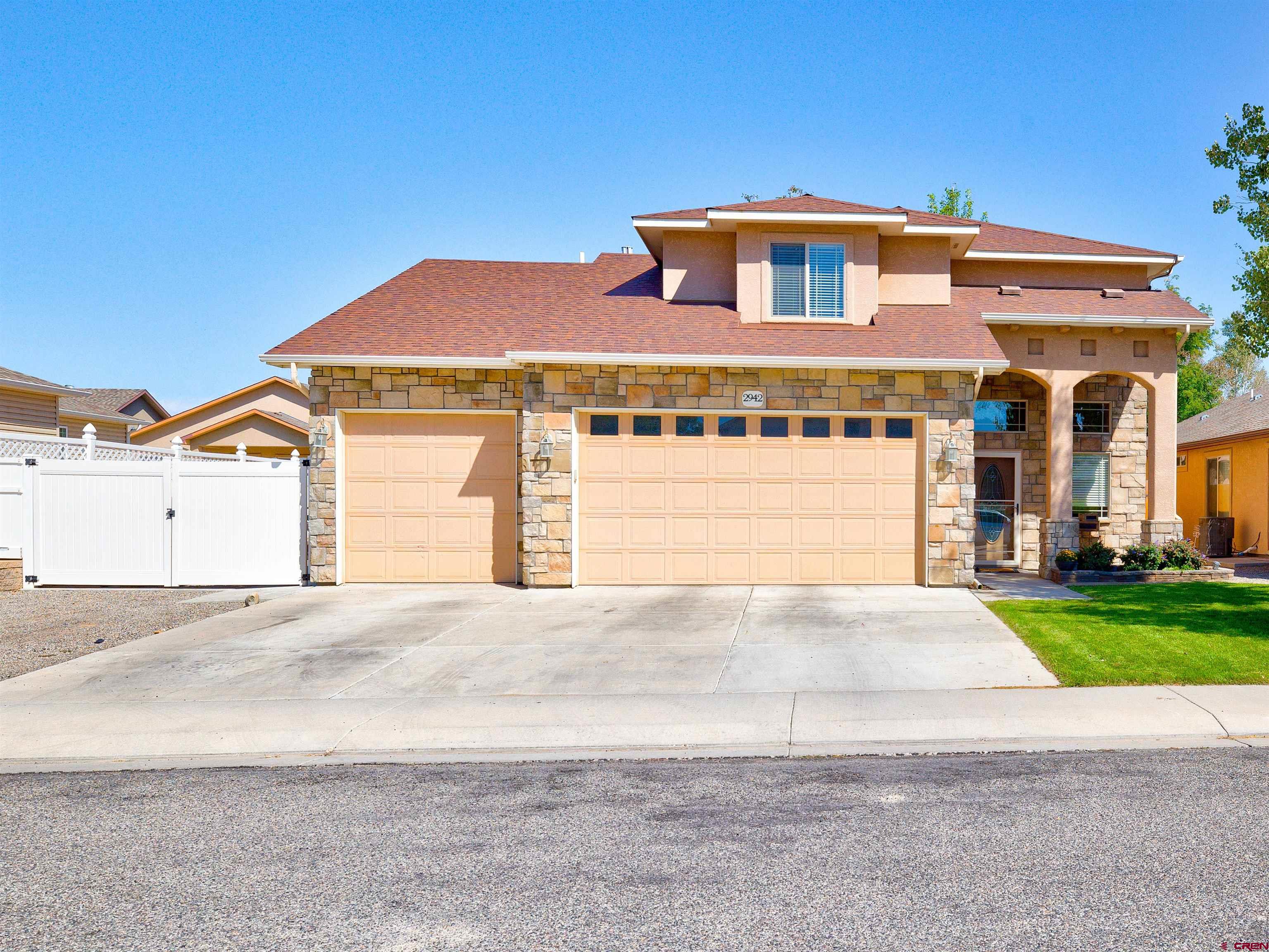 2942 F 1/4 Road Grand Junction, CO 81504 - Photo 1 of 32 a front view of a house with a yard