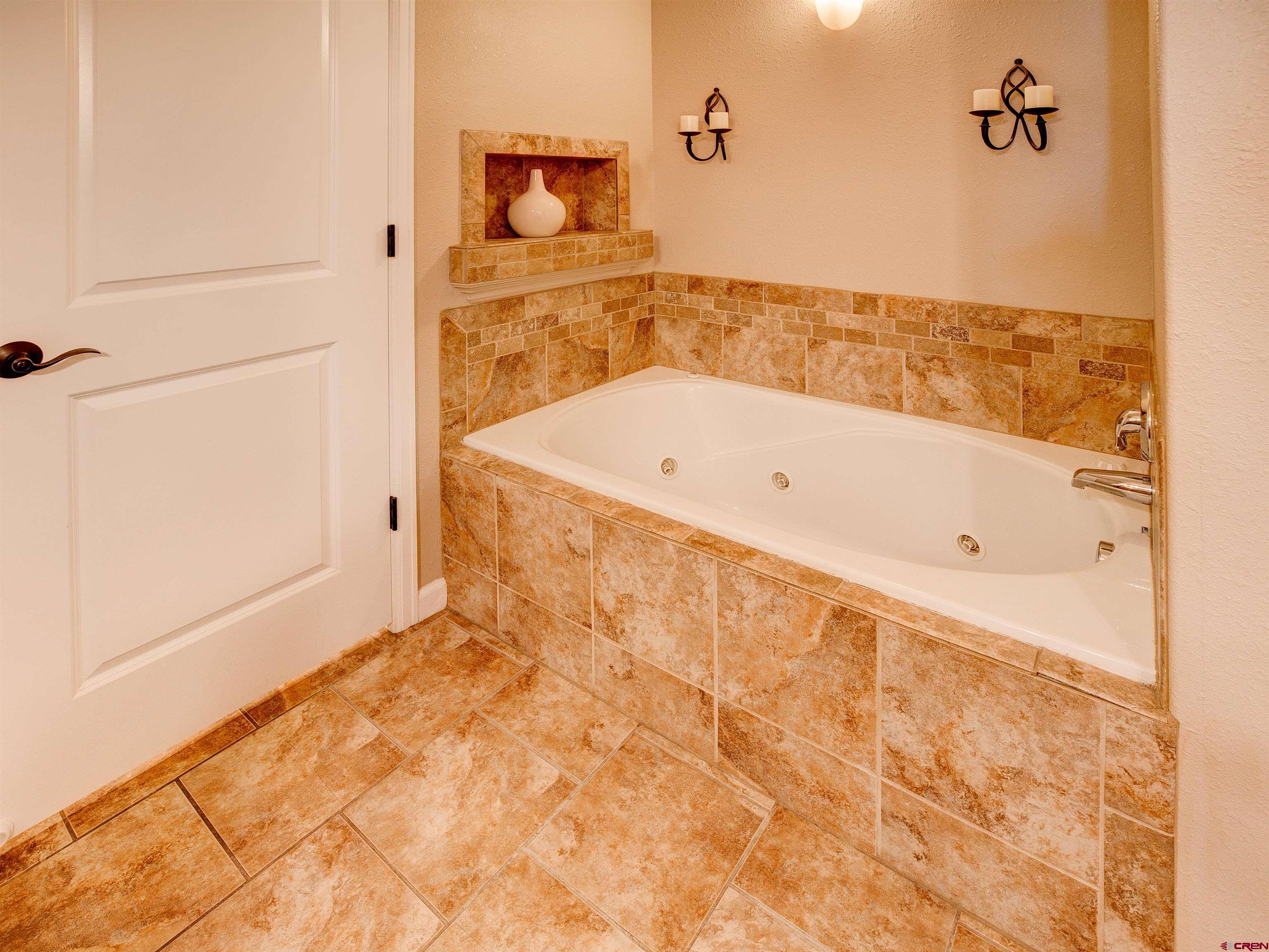 2942 F 1/4 Road Grand Junction, CO 81504 - Photo 19 of 32 a bathroom with a bathtub and shower