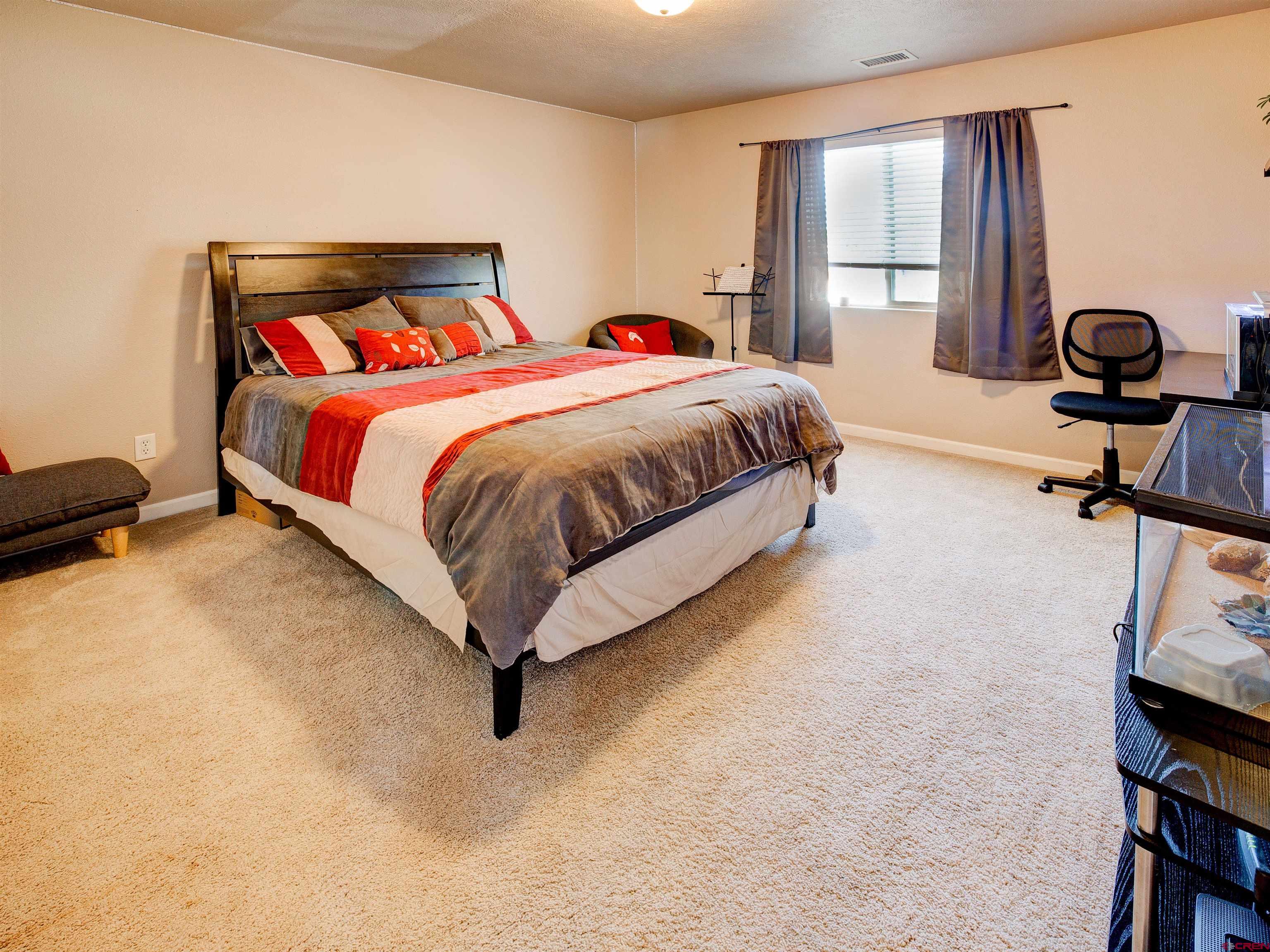 2942 F 1/4 Road Grand Junction, CO 81504 - Photo 22 of 32 a spacious bedroom with a bed and window