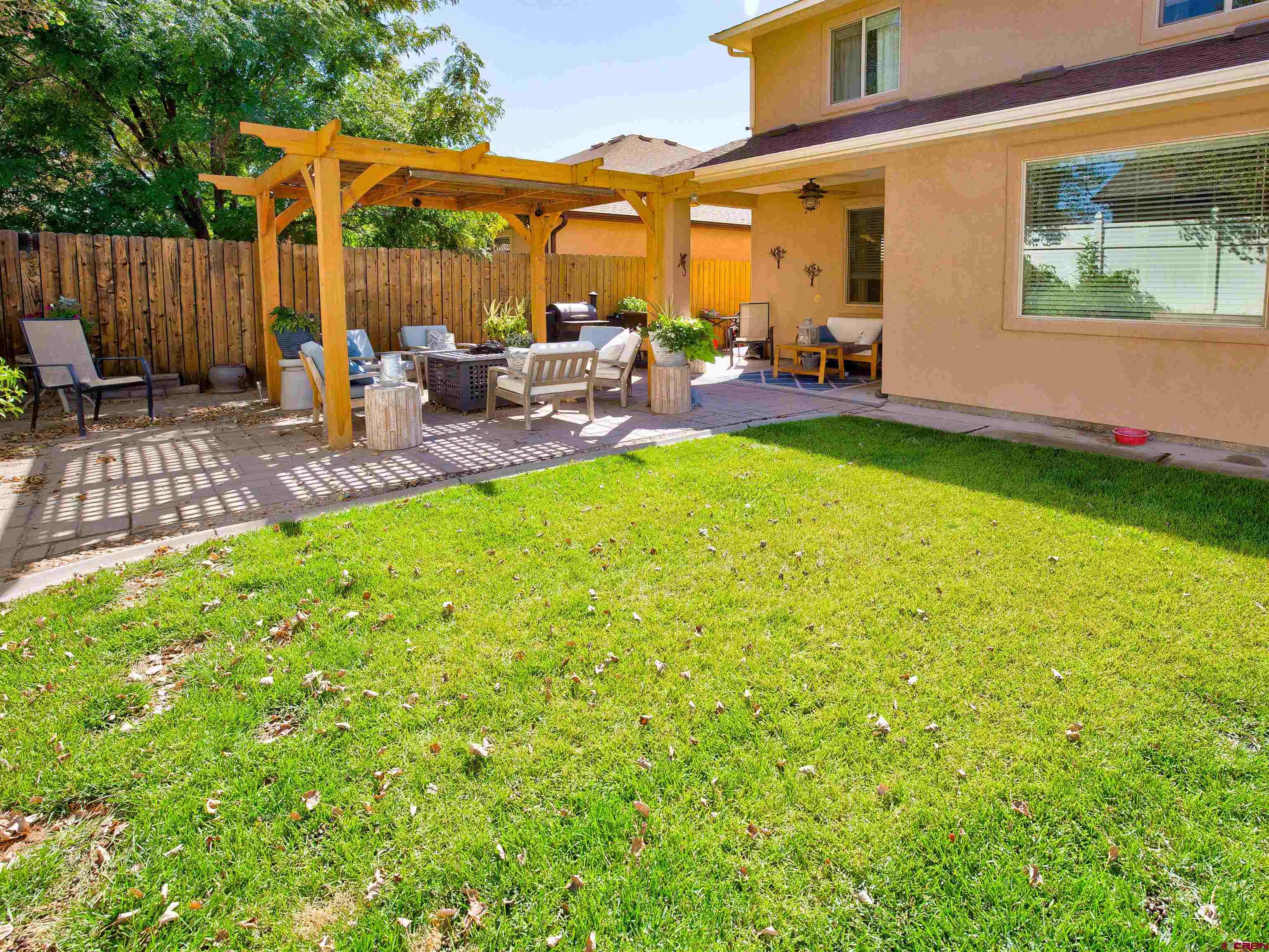 2942 F 1/4 Road Grand Junction, CO 81504 - Photo 28 of 32 a view of a patio with table and chairs and potted plants