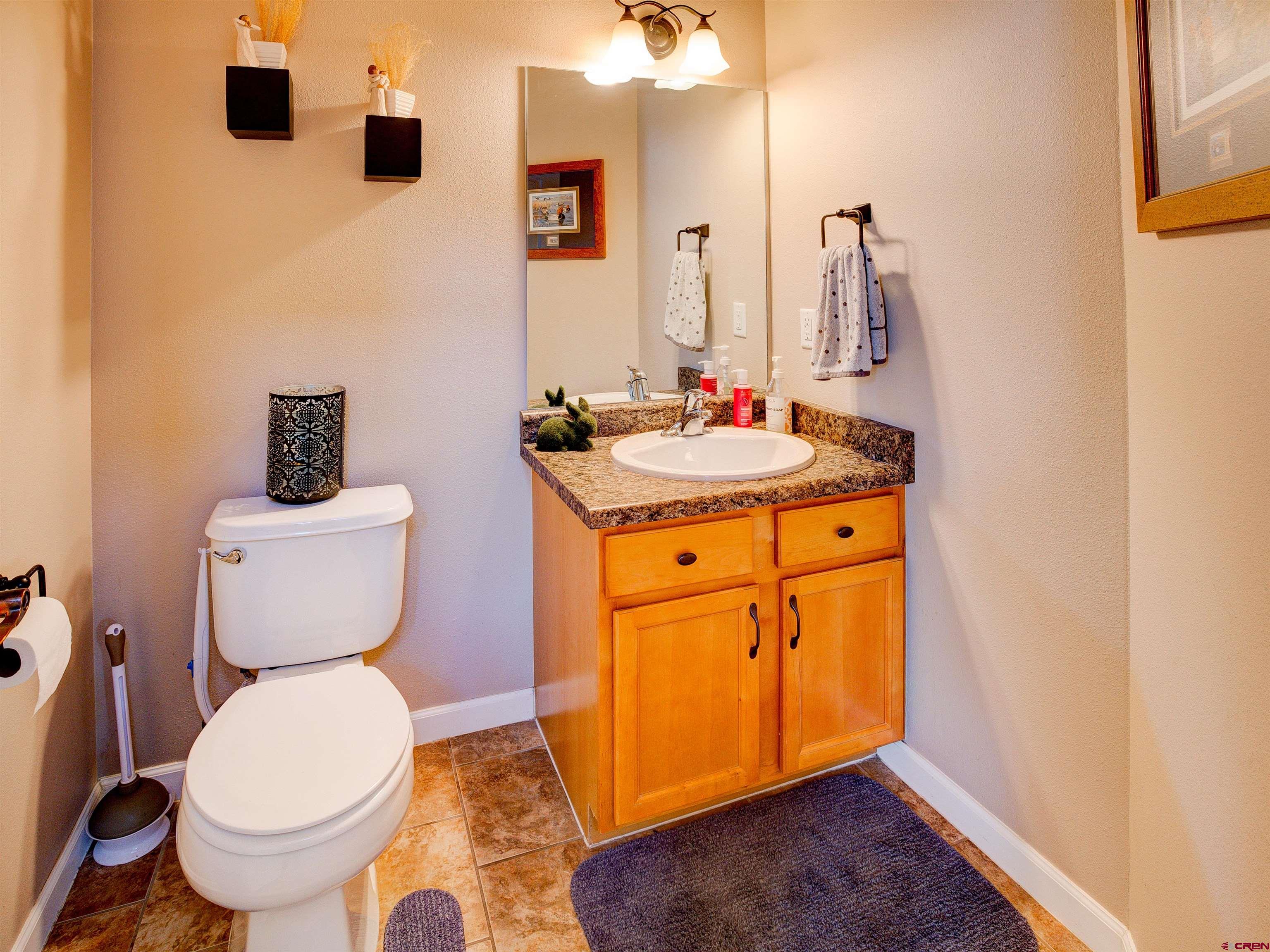 2942 F 1/4 Road Grand Junction, CO 81504 - Photo 7 of 32 a bathroom with a toilet sink and mirror