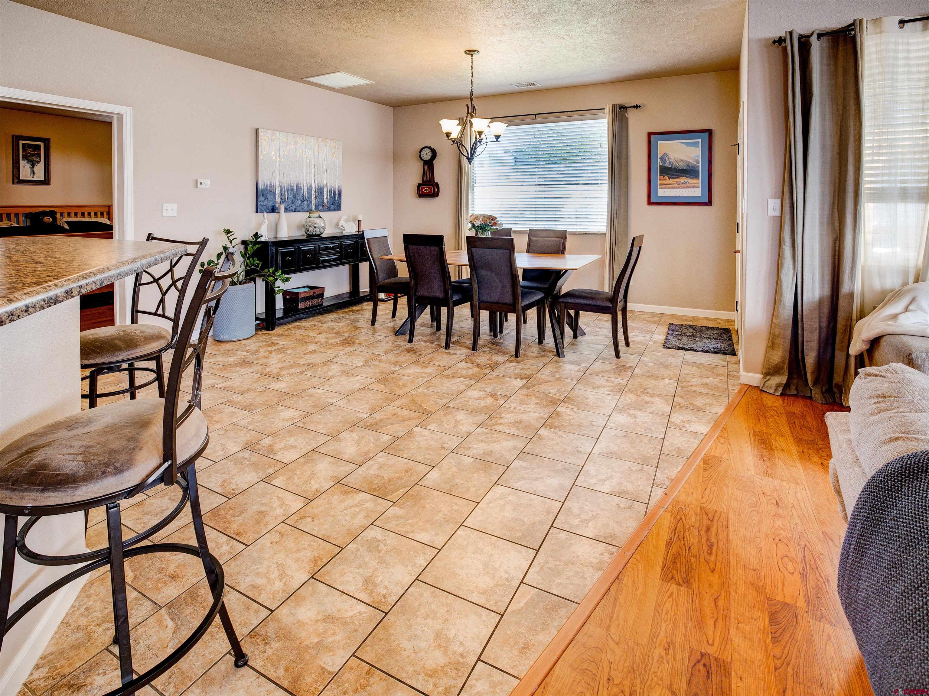 2942 F 1/4 Road Grand Junction, CO 81504 - Photo 9 of 32 a dining room filled with furniture and chandelier