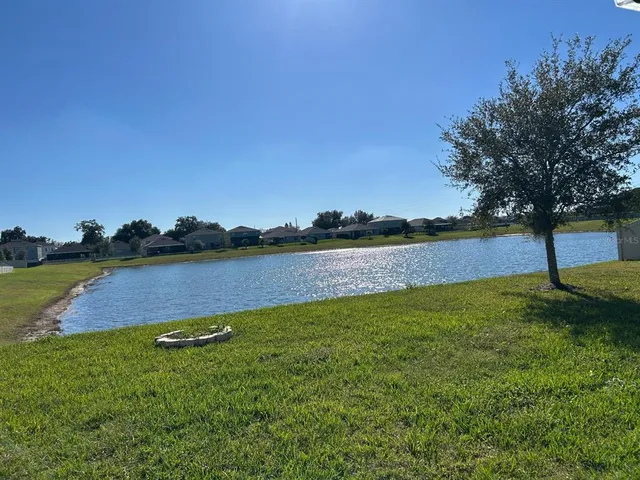 a view of a lake with houses in the back